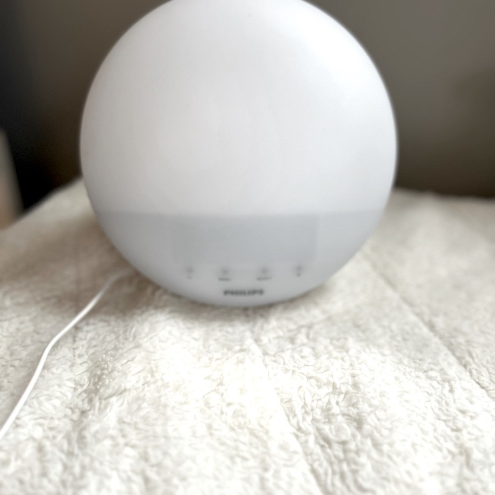 Alarm clock that simulates the sun and plays soothing wake up sounds